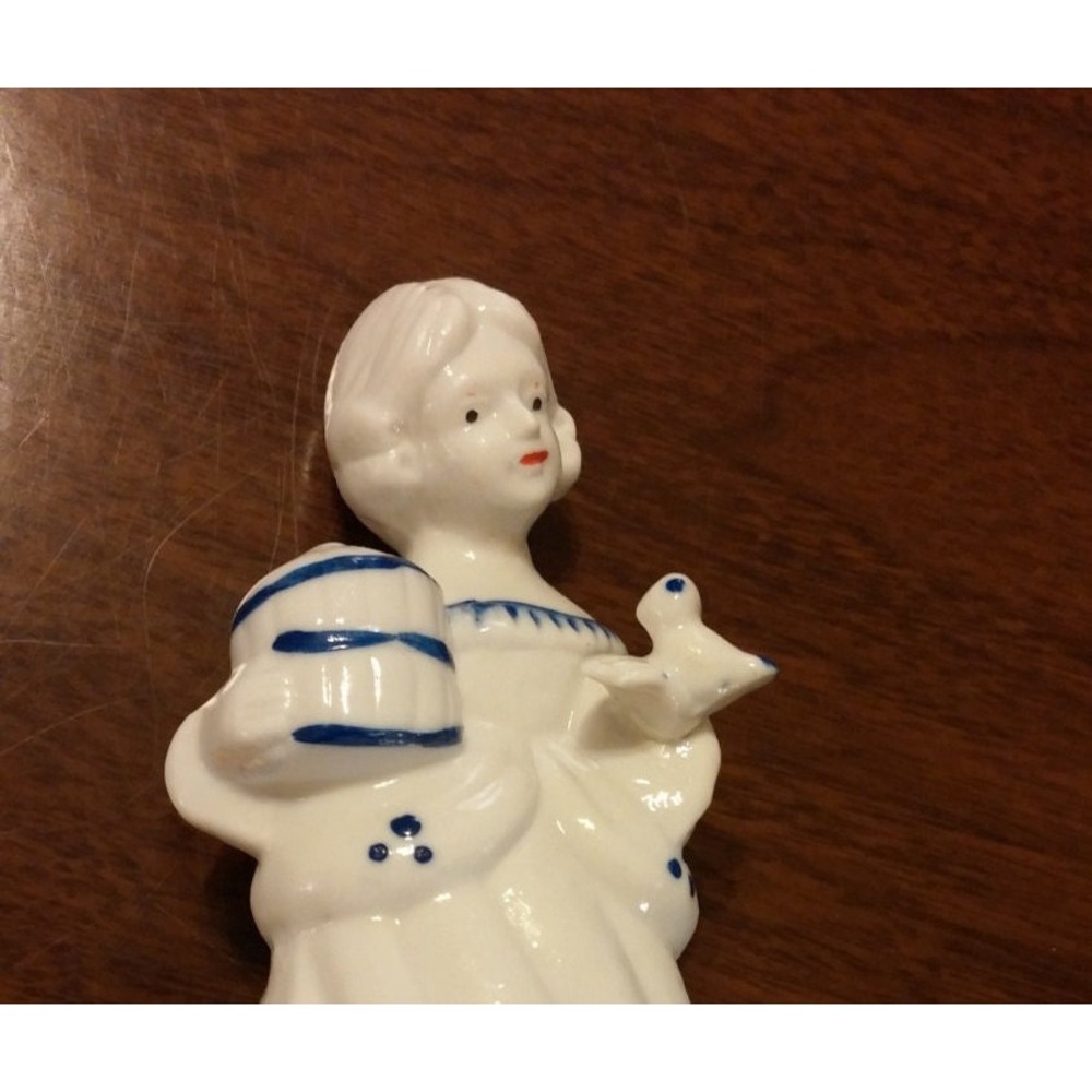 Porcelain girl with bird figurine, Delft style